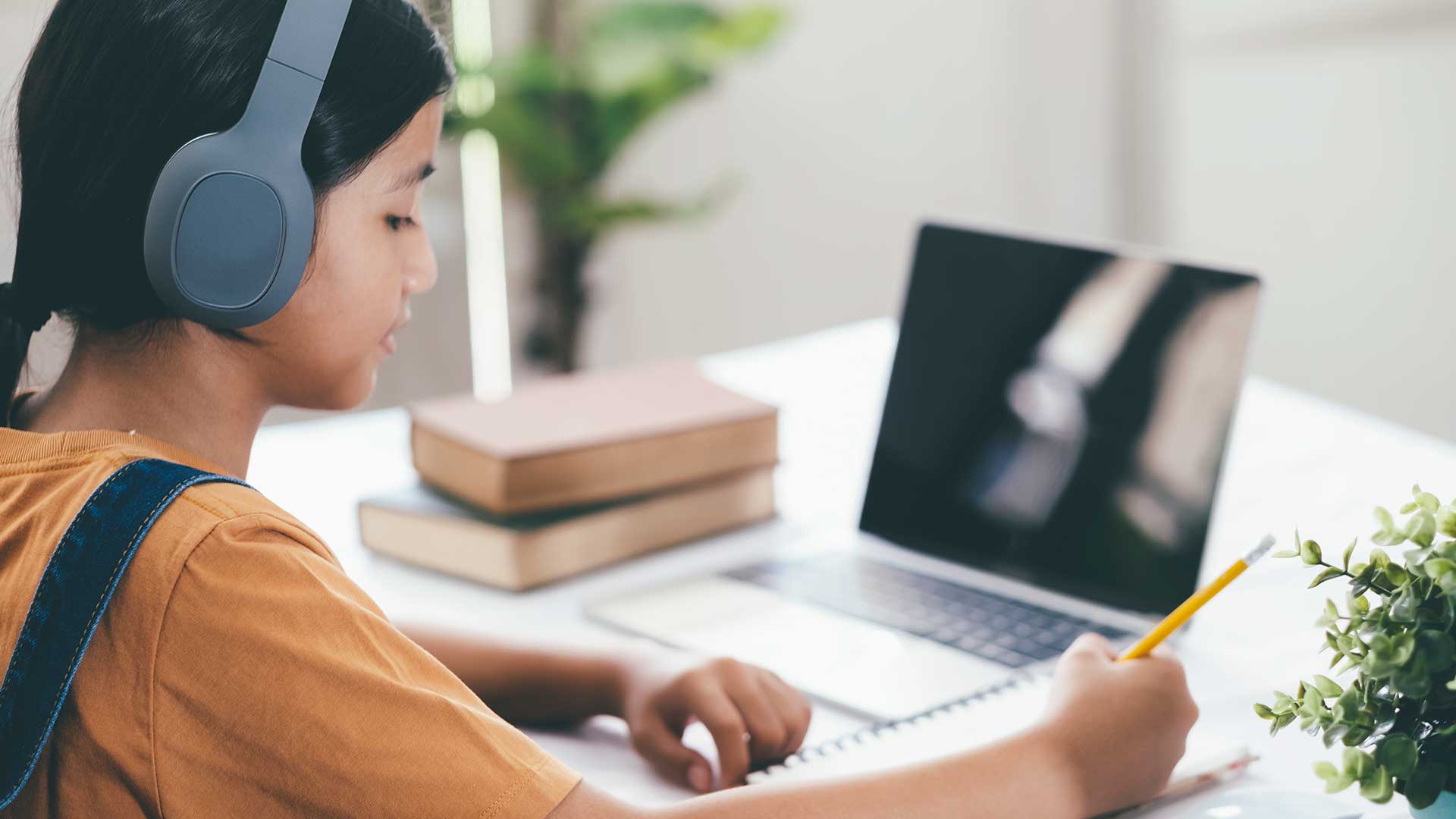Girl learning at home on a computer
