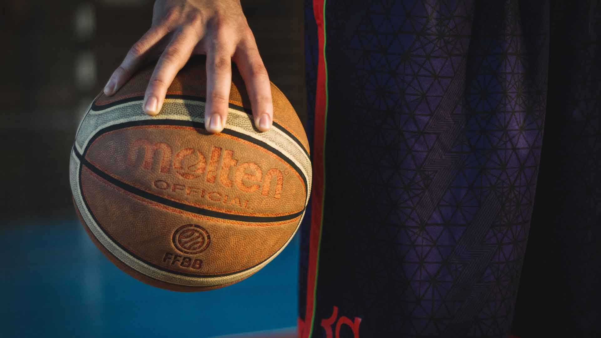 teen gripping a basketball