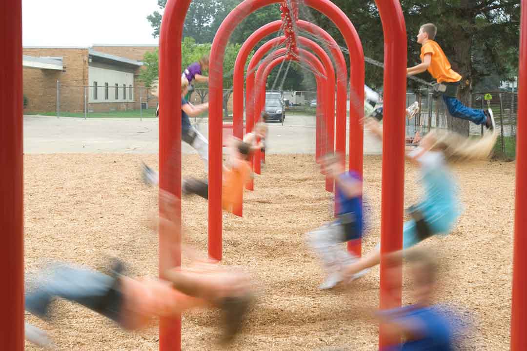 Powerscape swing with many children swinging, motion blurred