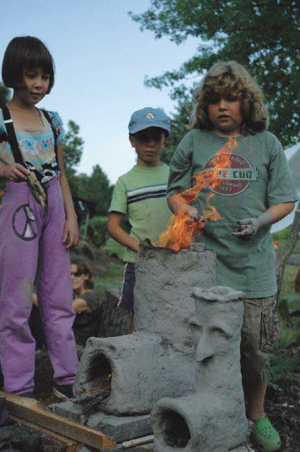 Children cooking over a fire