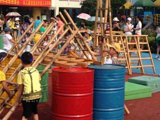 Kid with ladders and colorful barrels