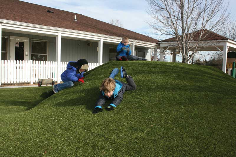 Kids can safely romp and roll around on soft synthetic grass. Security Benefit child care facility, Topeka, KS.