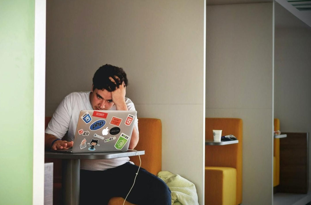 College student playing games on laptop