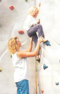 child climbing rock wall