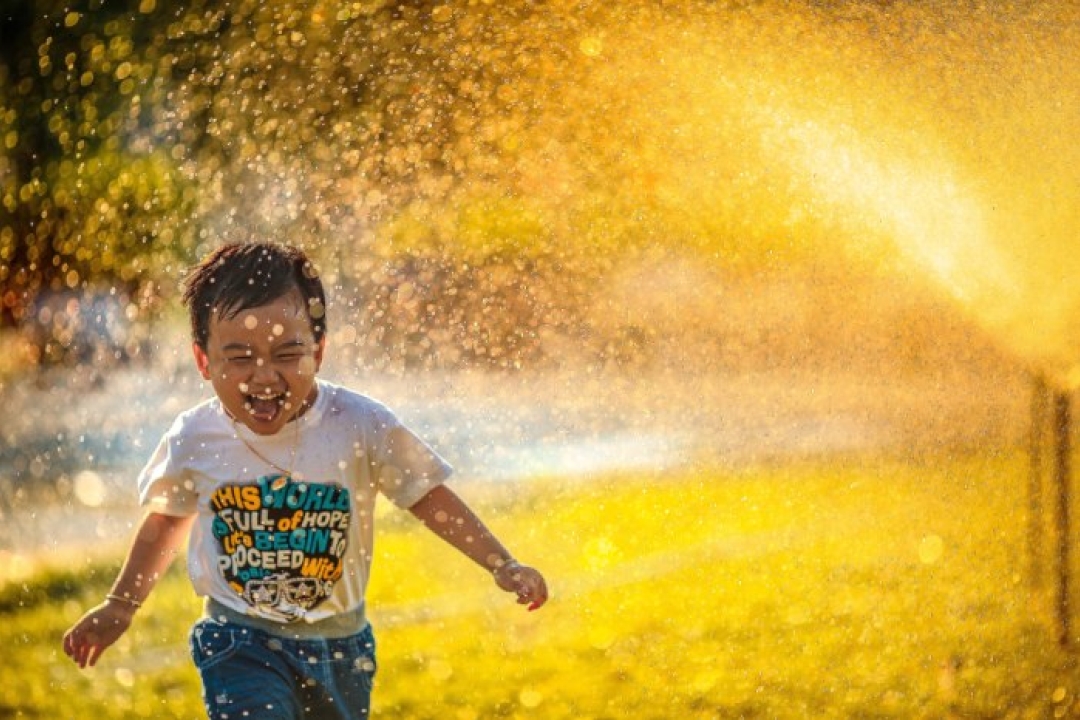 Kid Running through Sprinkler