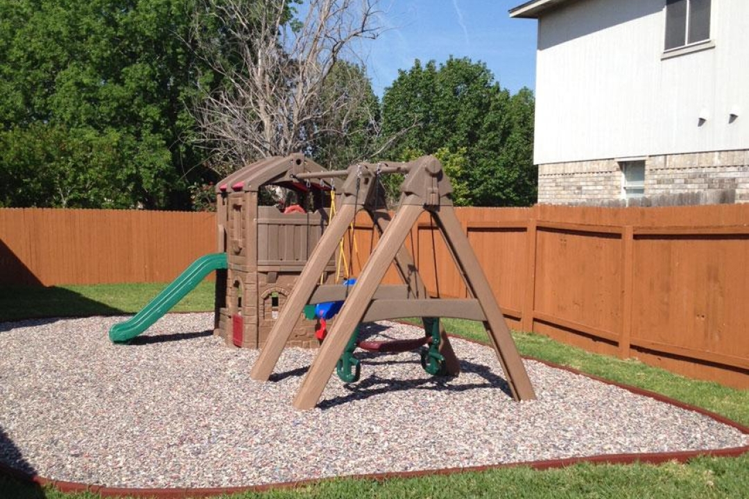 Jelly Bean rubber mulch under a backyard playset