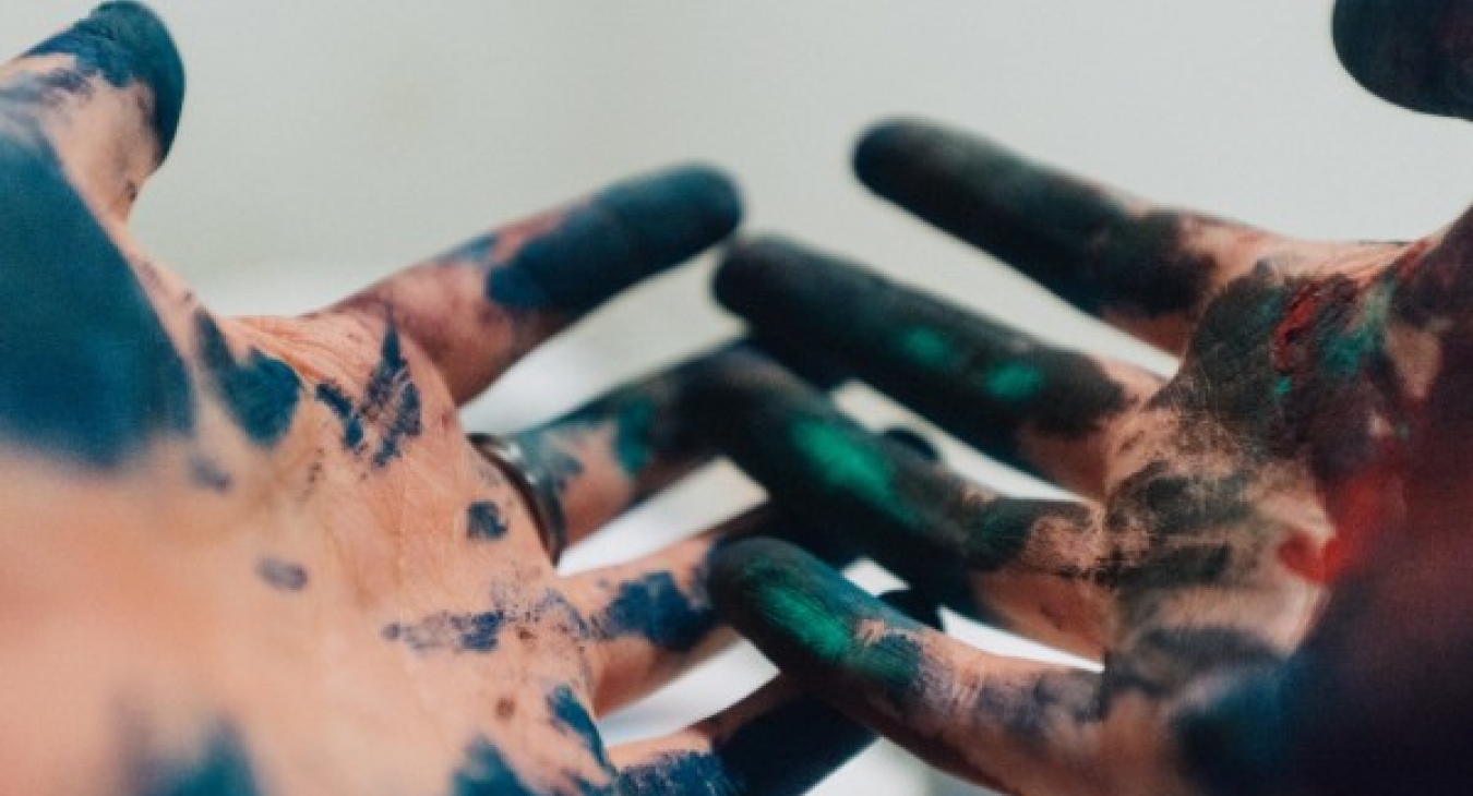 A child's paint-covered hands