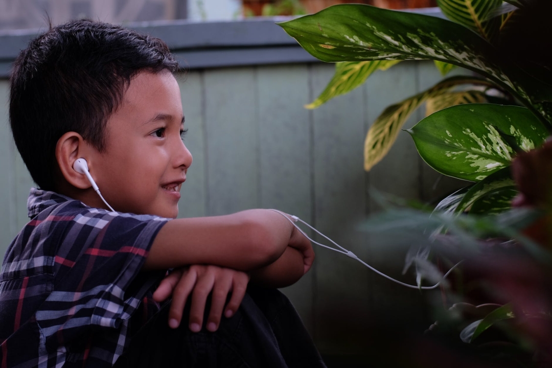 Boy wearing earphones.