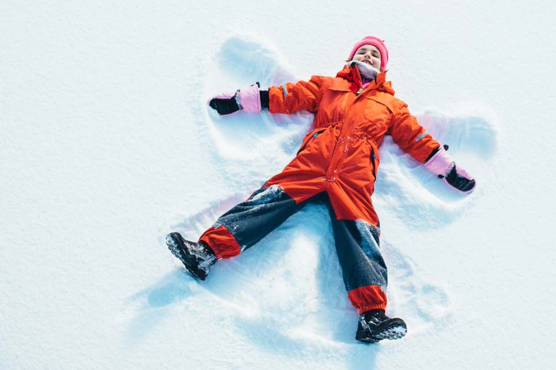 Child making snow angels