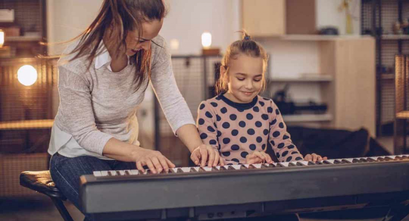 Mom and daughter playing keyboard