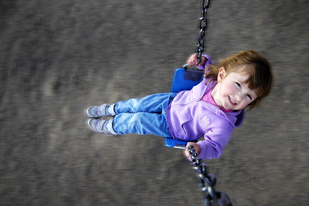 girl swinging on a swing set
