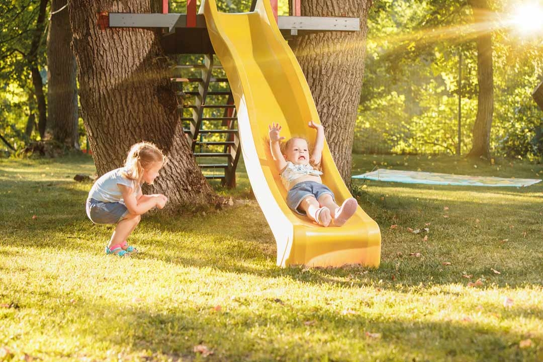 Child sliding on a backyard slide