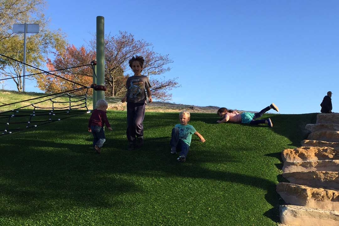children playing on a sloped playground