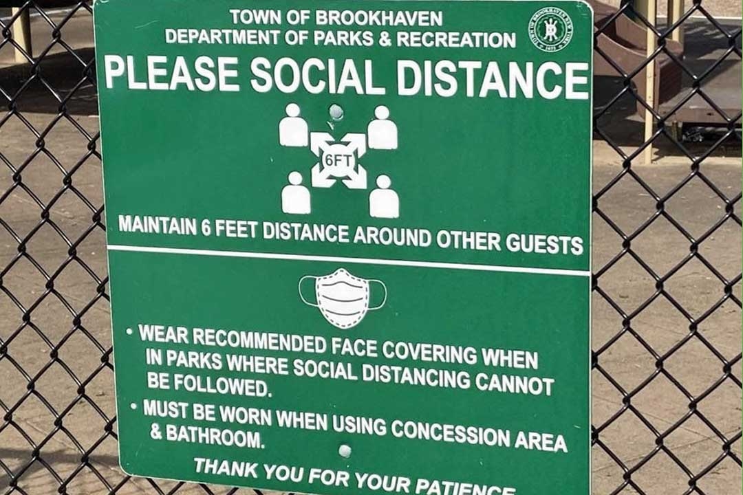 sign recommending social distancing and mask wearing