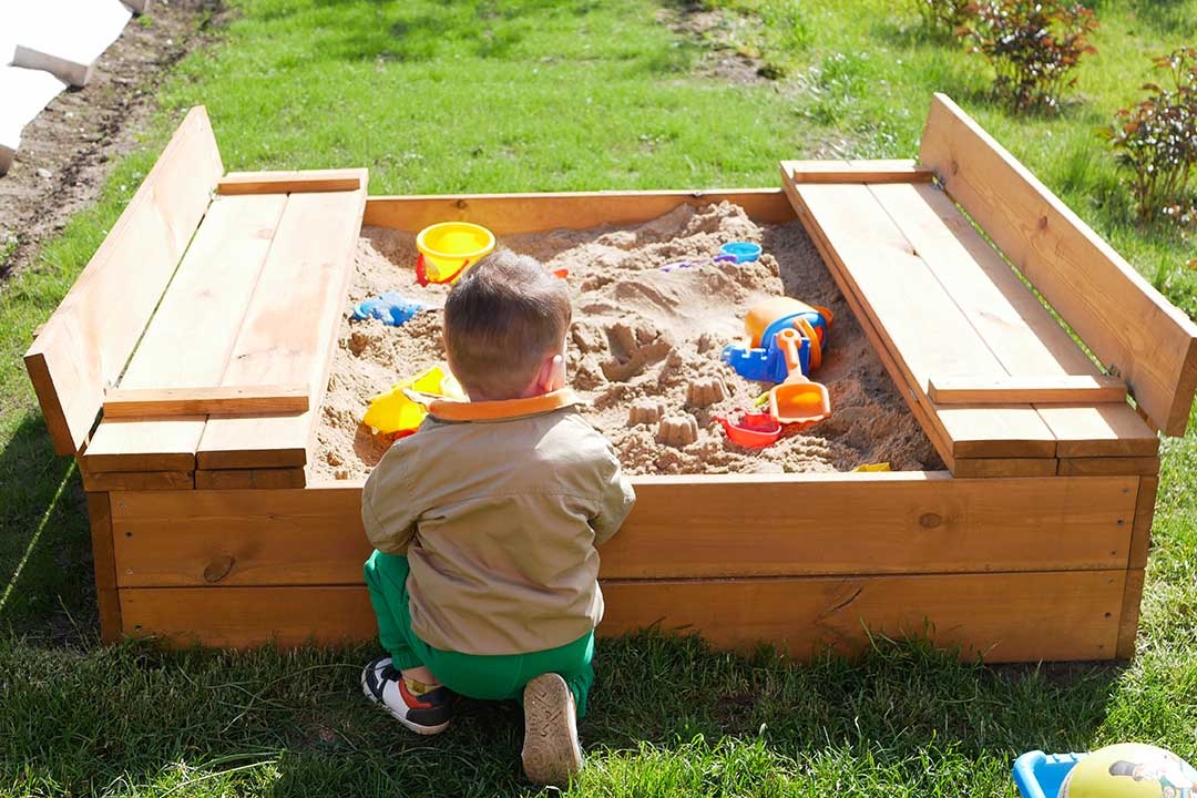 child spends time playing in sandbox