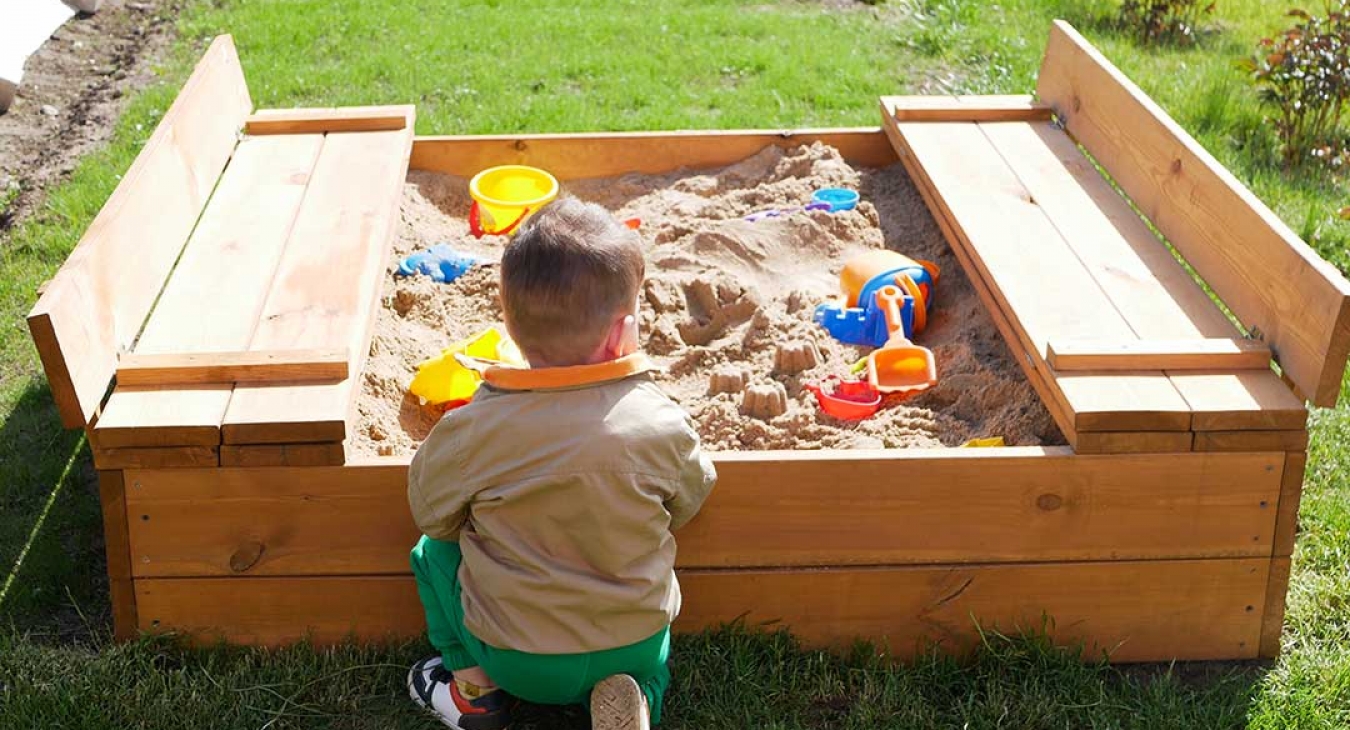 child spends time playing in sandbox