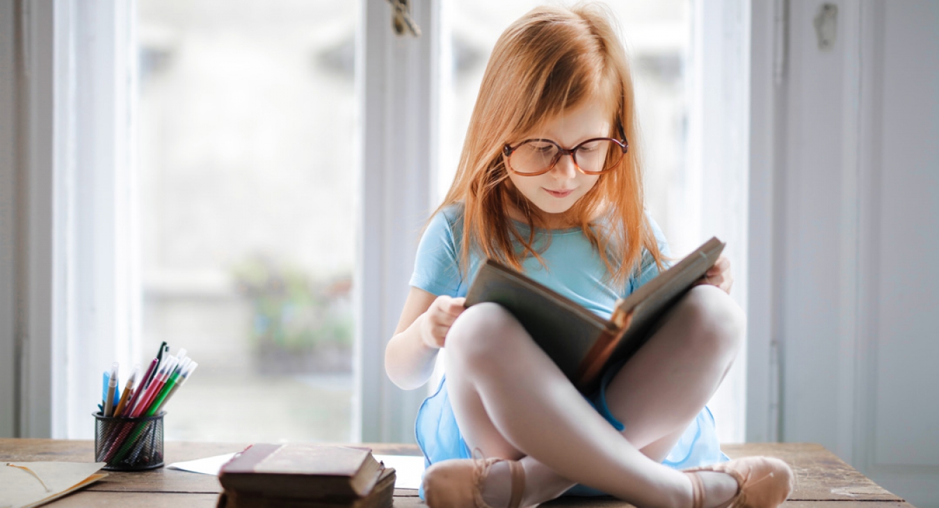 Little girl reading a book