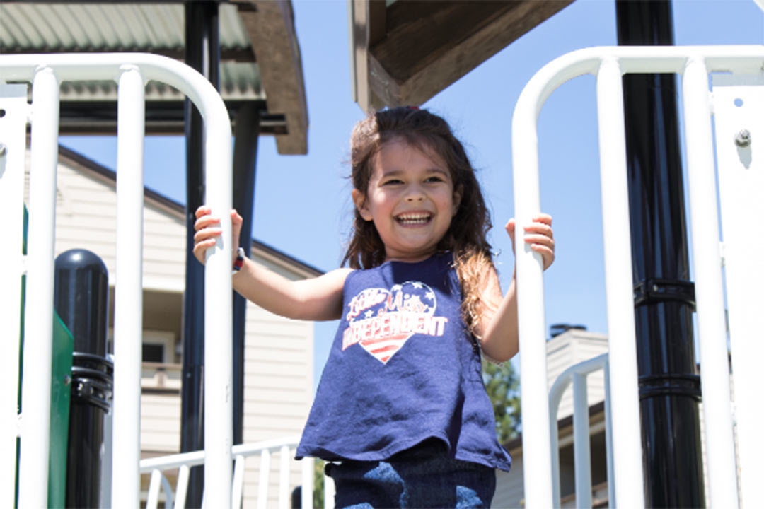Girl on top of sanitized playground equipment