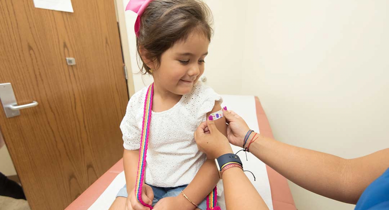 girl at doctors office getting first aid