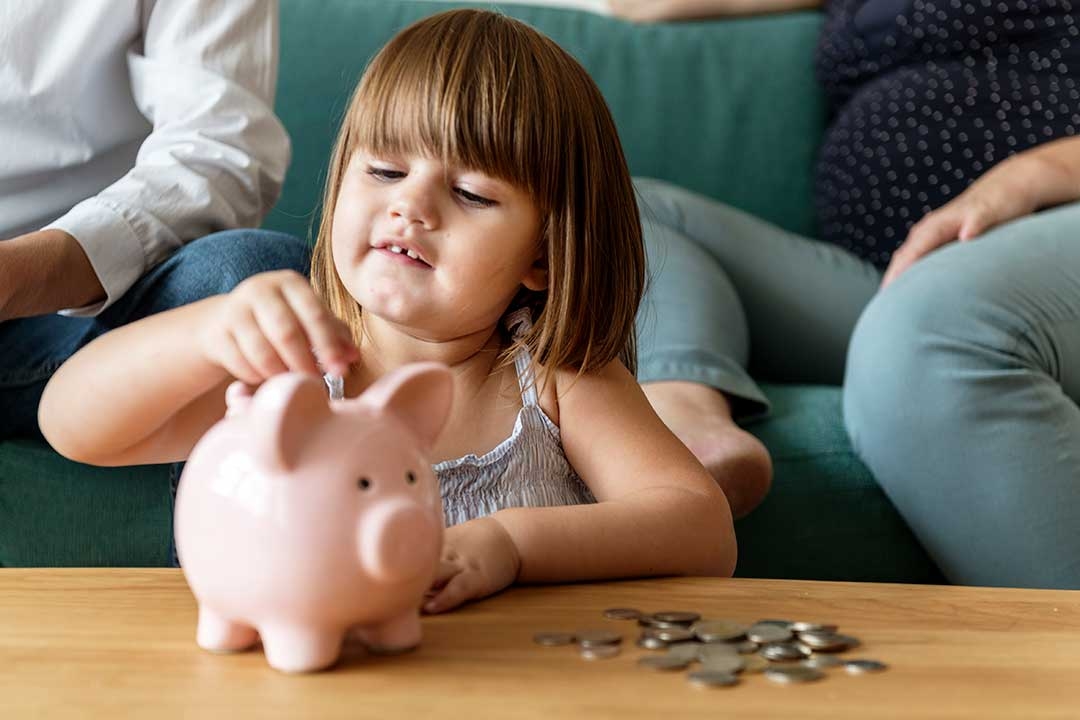family saving money in a piggy bank