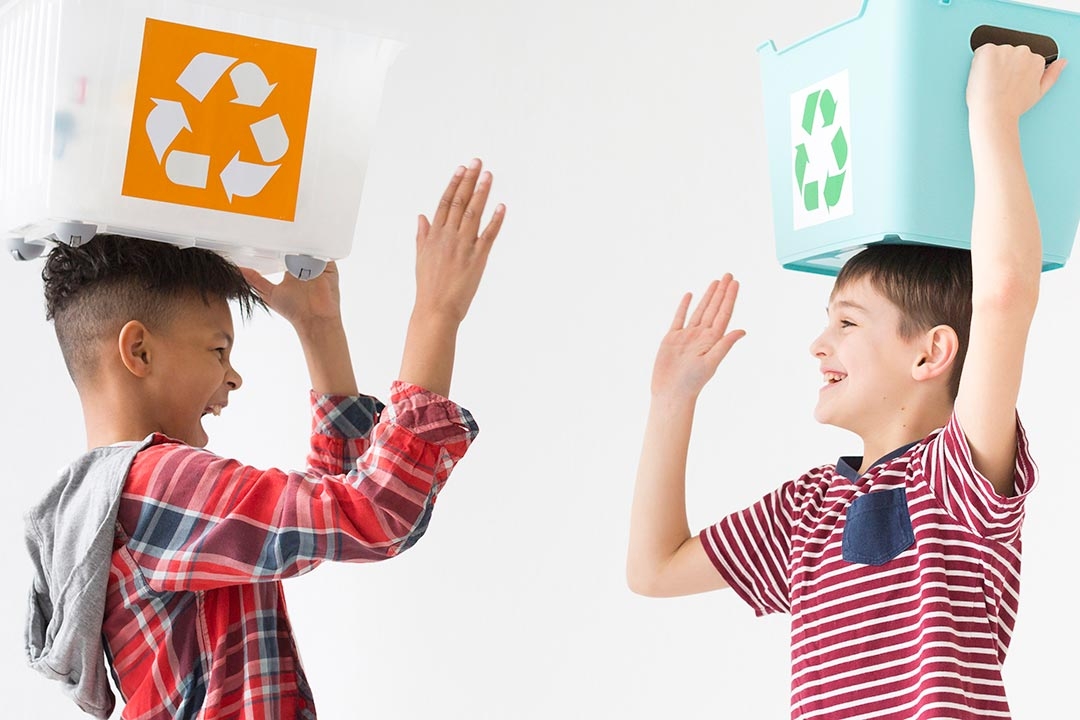young boys happy to recycle together