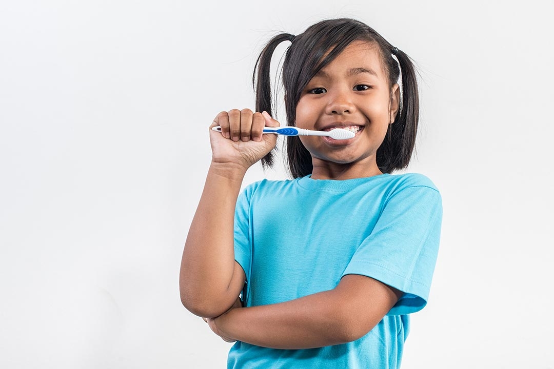 girl brushing her teeth
