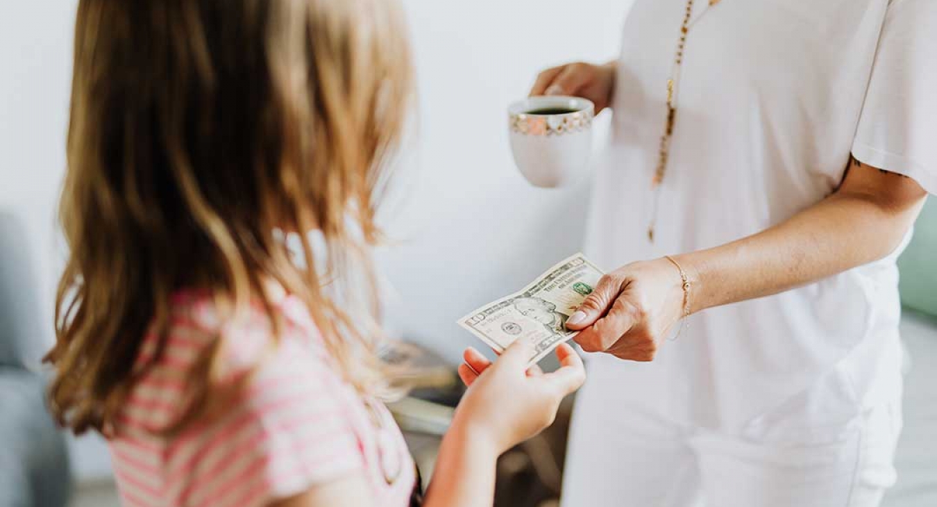 grandmother giving granddaughter money