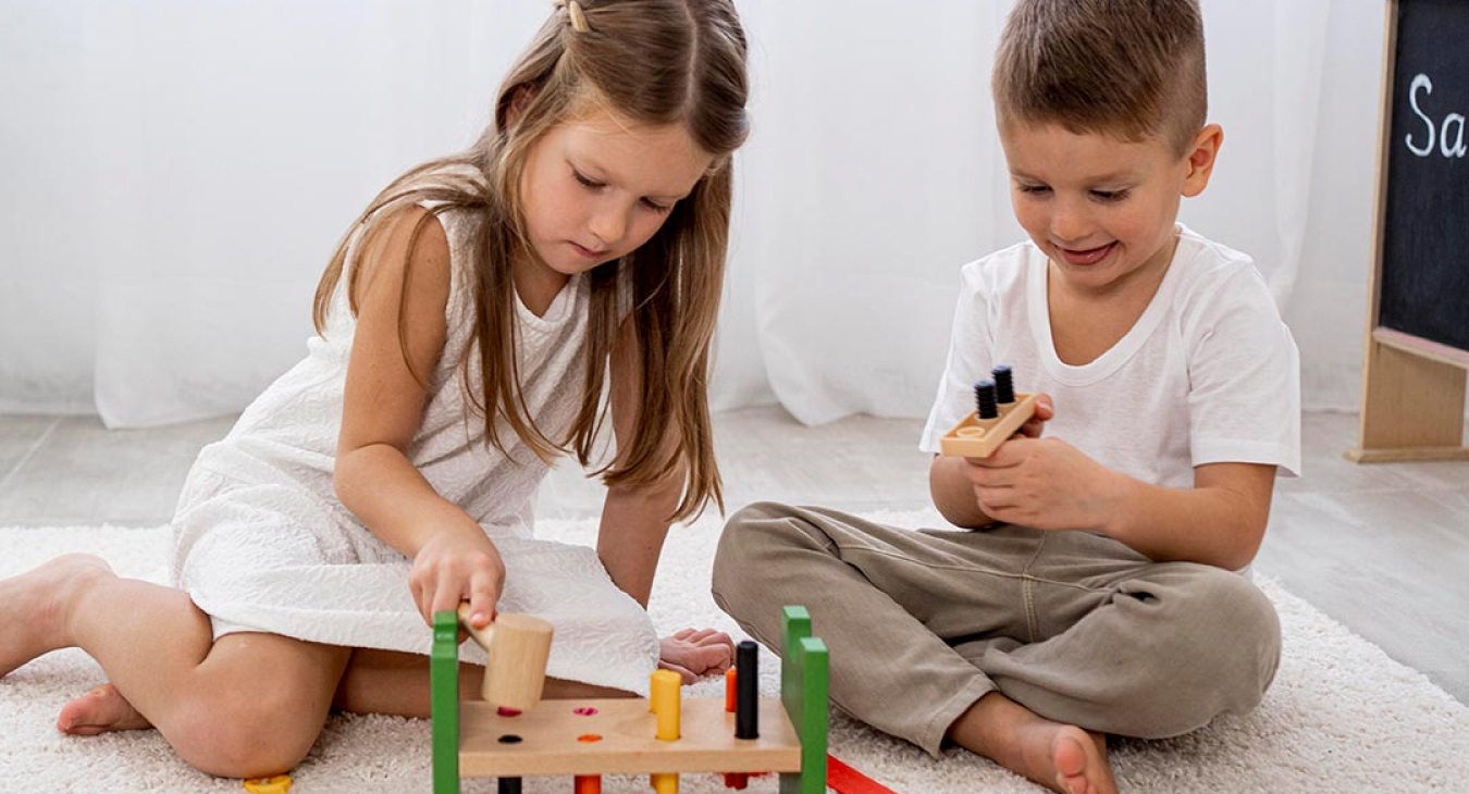 boy and girl playing with wooden toys