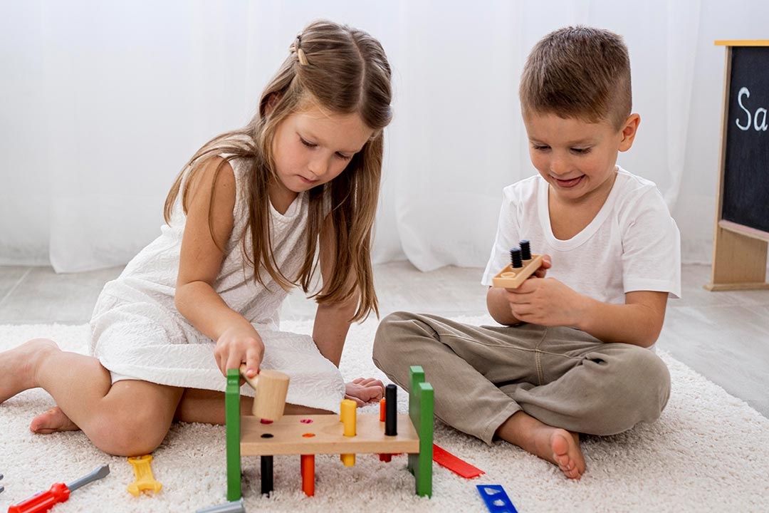 boy and girl playing with wooden toys