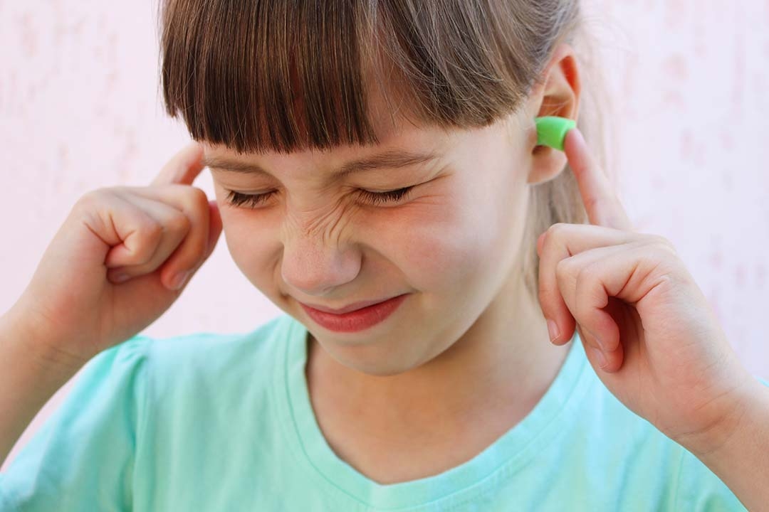 girl wearing ear plugs