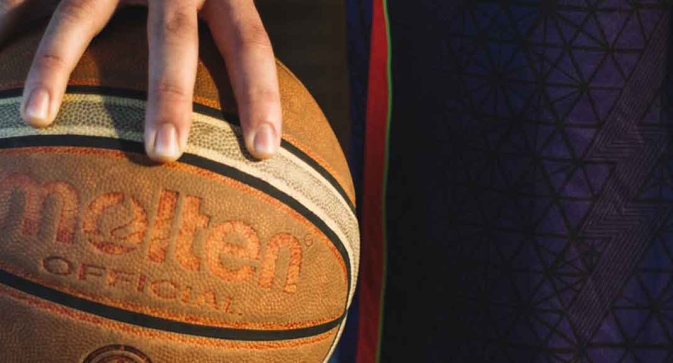 teen gripping a basketball