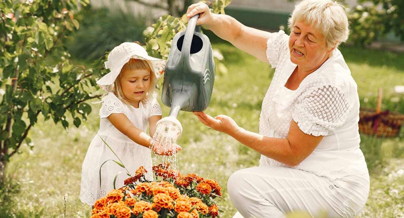 Grandmother gardening with her granddaughter 