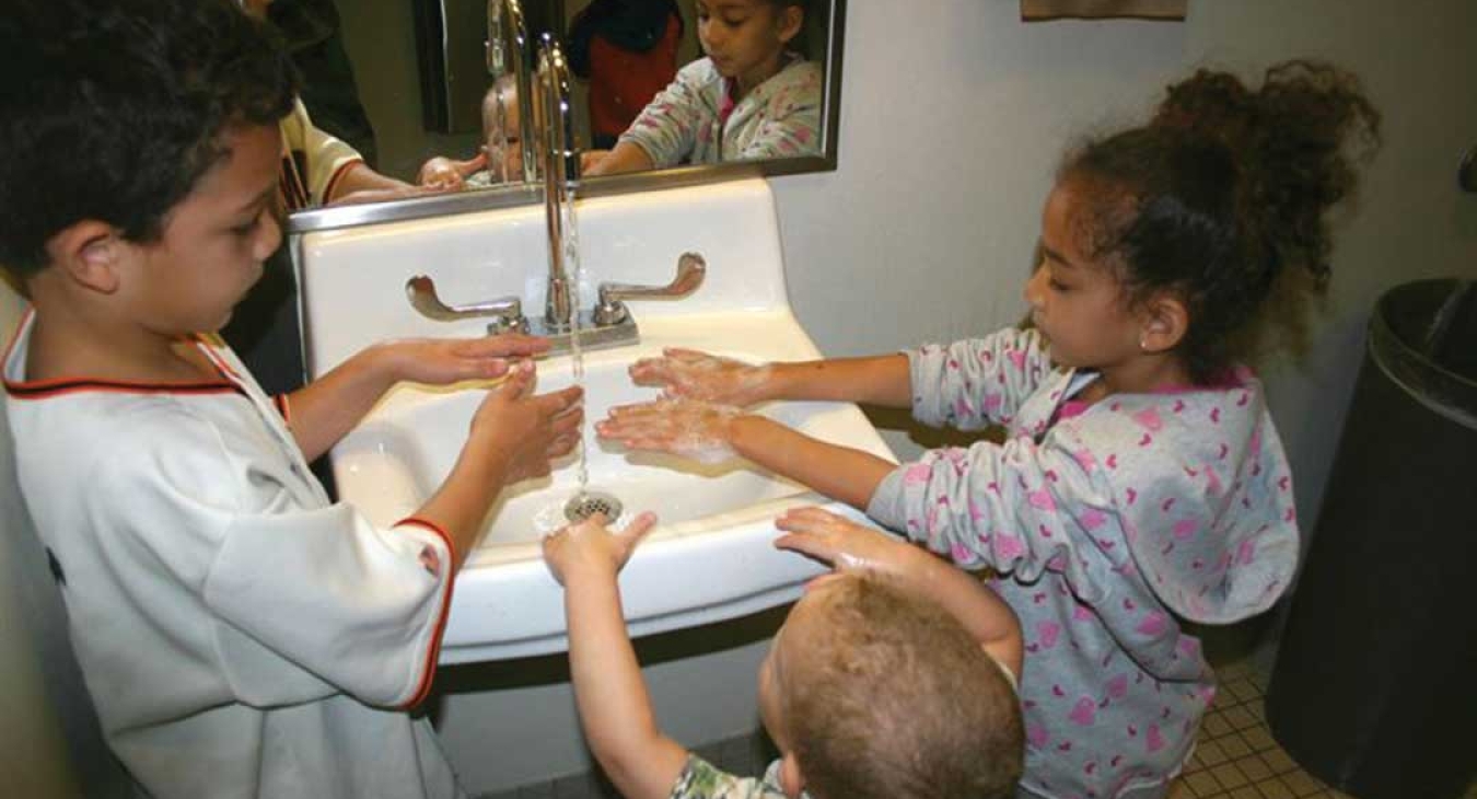 Kids washing hands after playing on a playground