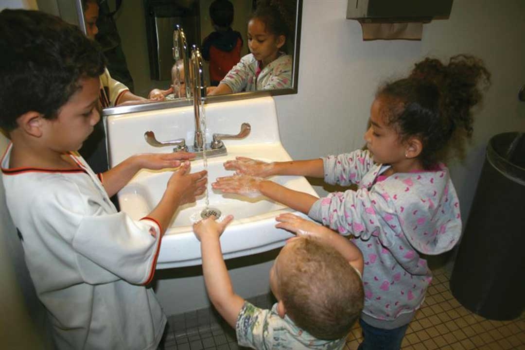 Kids washing hands after playing on a playground