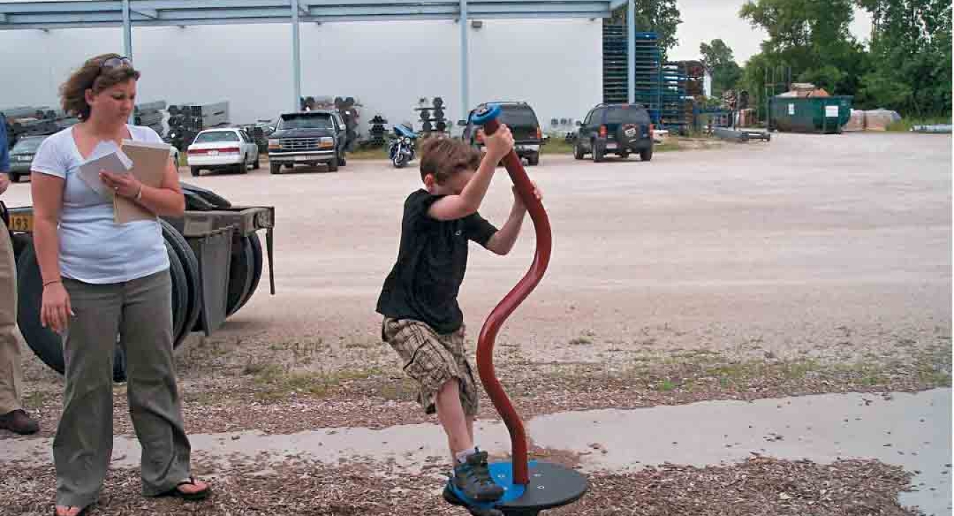 Boy playing on play equipment