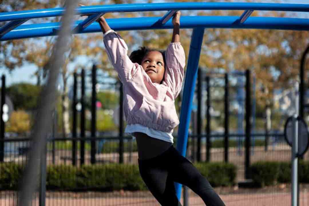 Kid on monkeybars
