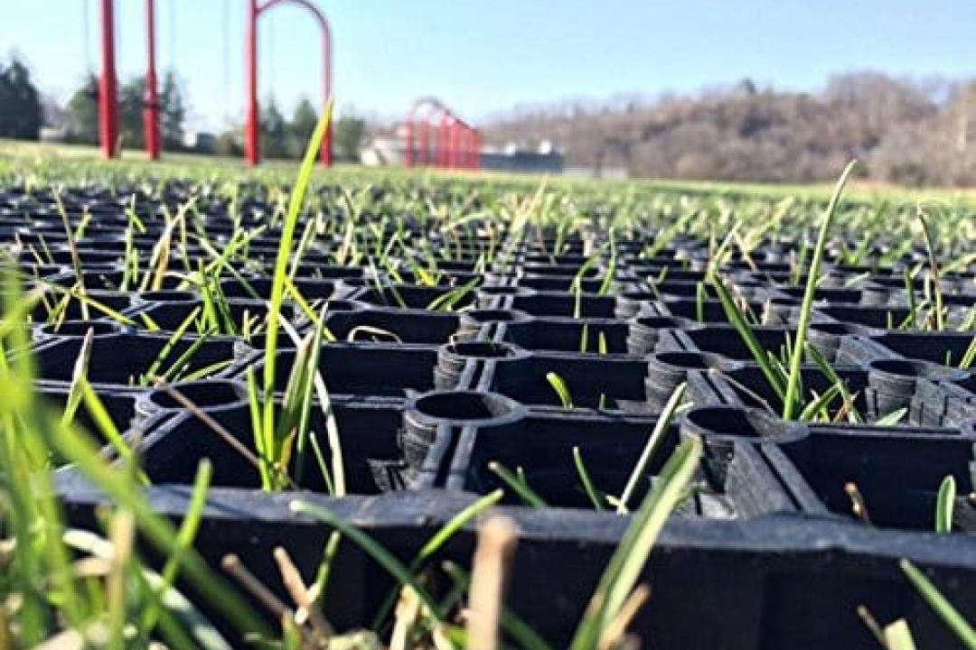 A rubber grass mat is a durable, easy-to-install ground cover that reinforces natural turf under playground equipment, providing reliable fall protection while preventing mud and wear.