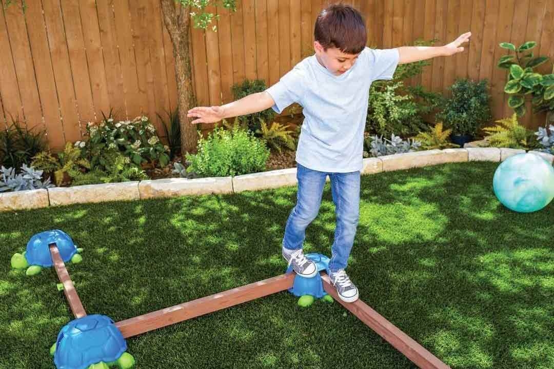 Child balancing on turtle stepping stones outdoor play equipment available from The Best Backyard Australia