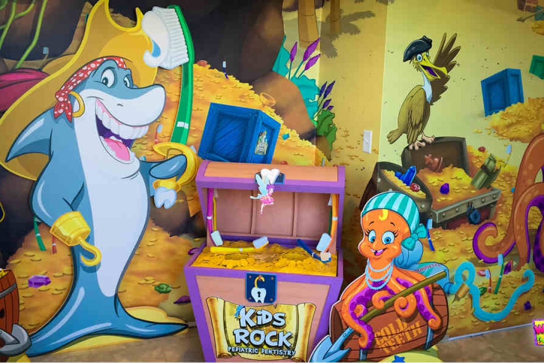 A colorful pirate-themed pediatric dental office features cartoon sea creatures and treasure-filled 3D wall art for Kids Rock Pediatric Dentistry.