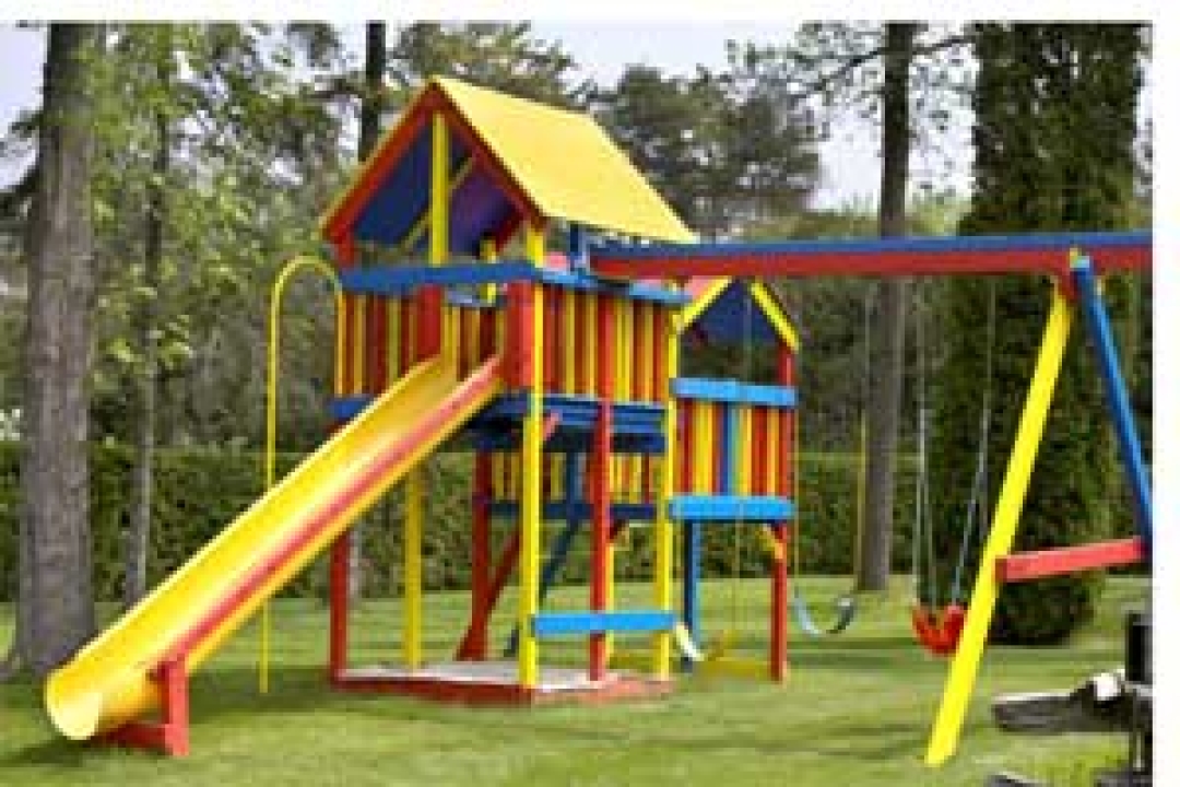 Grass as surfacing under playset