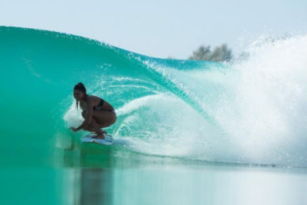 Woman surfing a Kelly Slater Wave