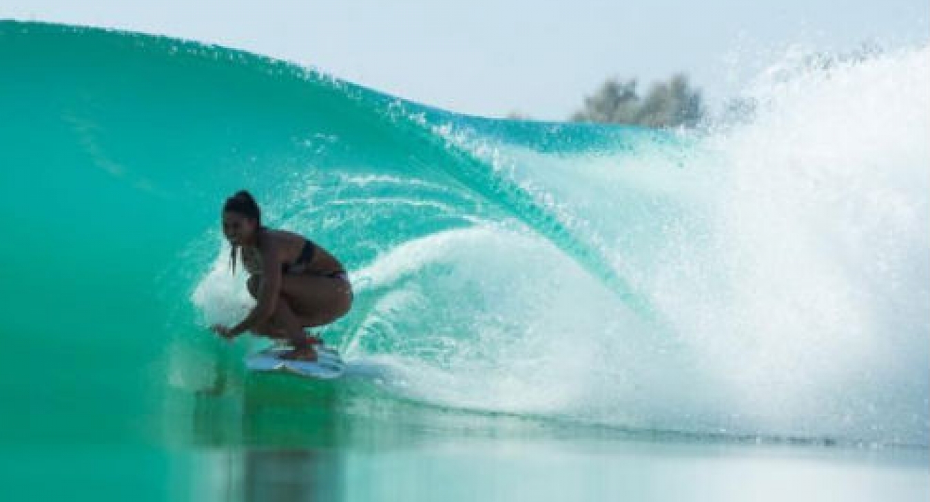 Woman surfing a Kelly Slater Wave