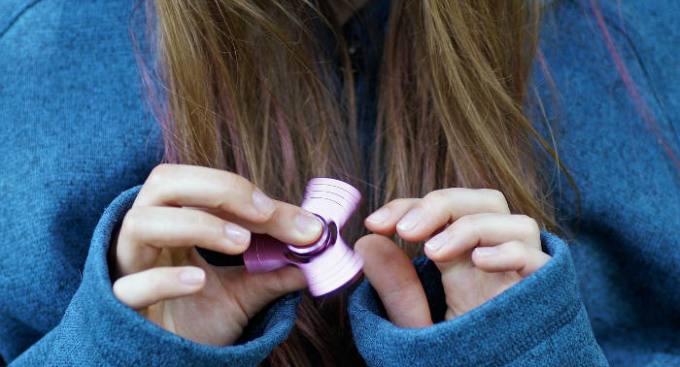 Girl playing with a fidget spinner