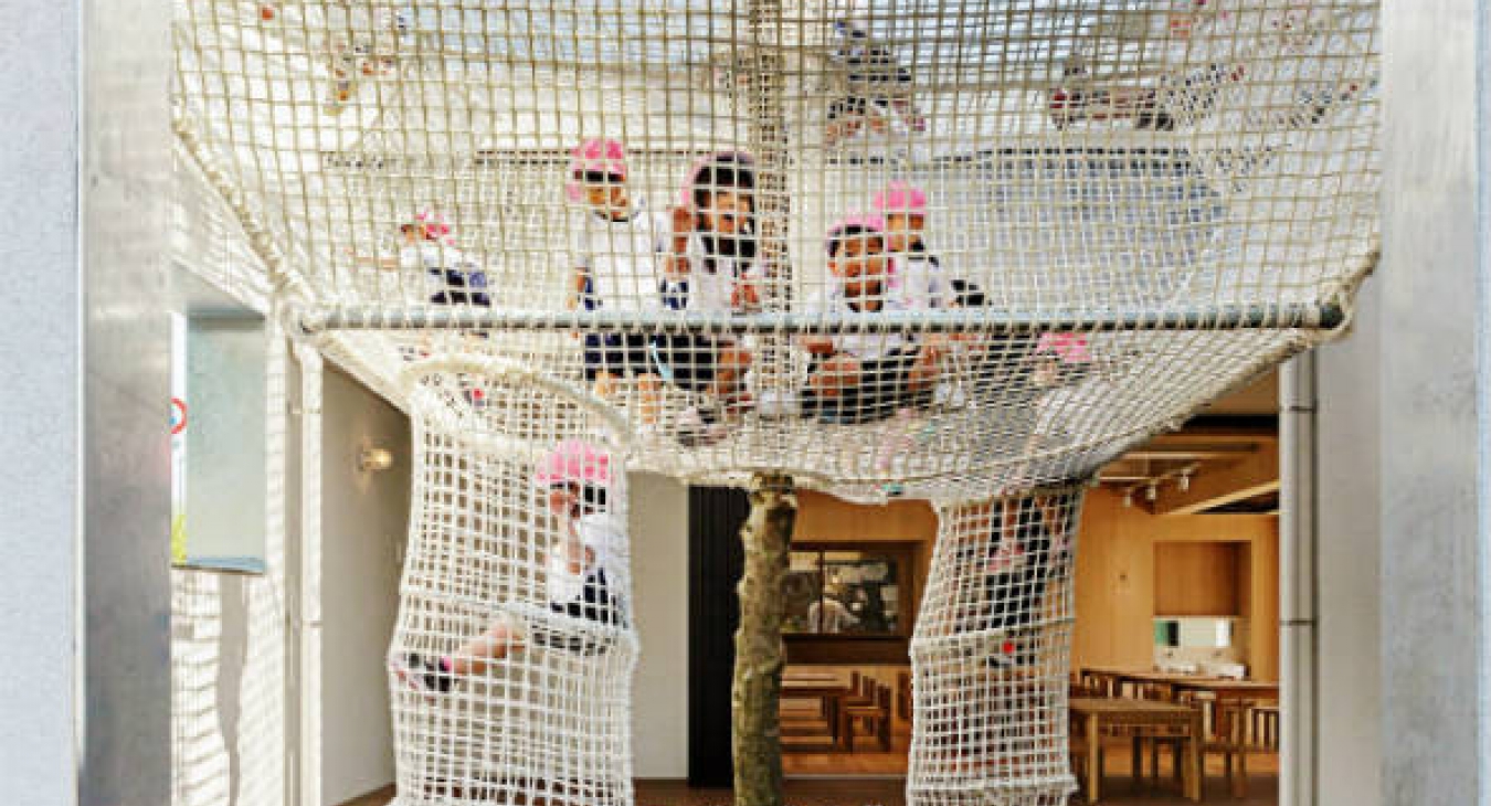 Children climb on nets in a nursery in Japan