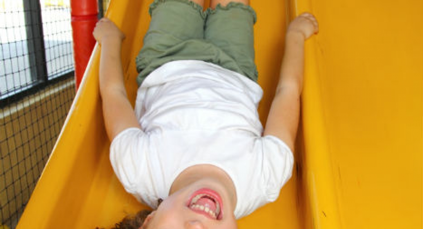 Girl playing on a slide.