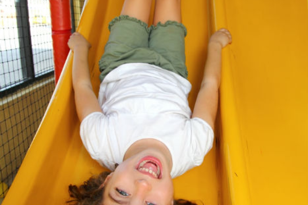 Girl playing on a slide.