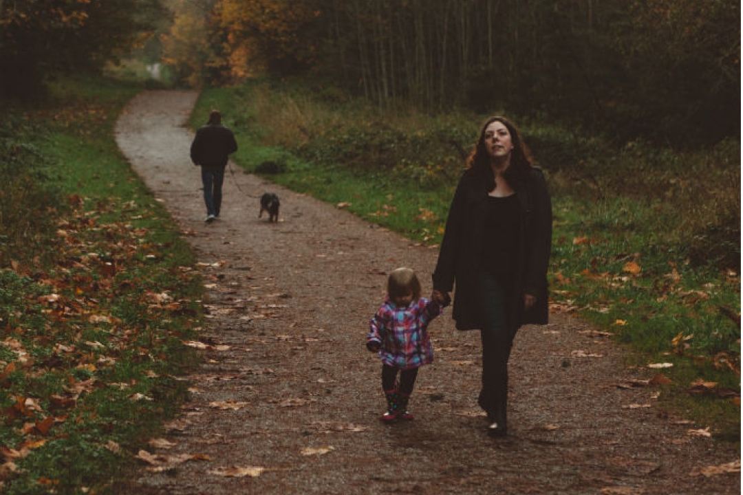 Mother & Daughter walking in a park