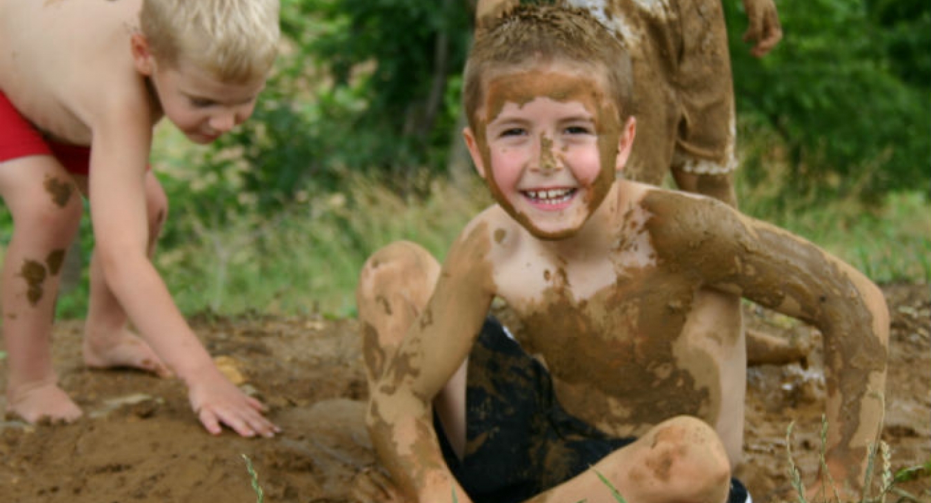 Boys playing in the mud.