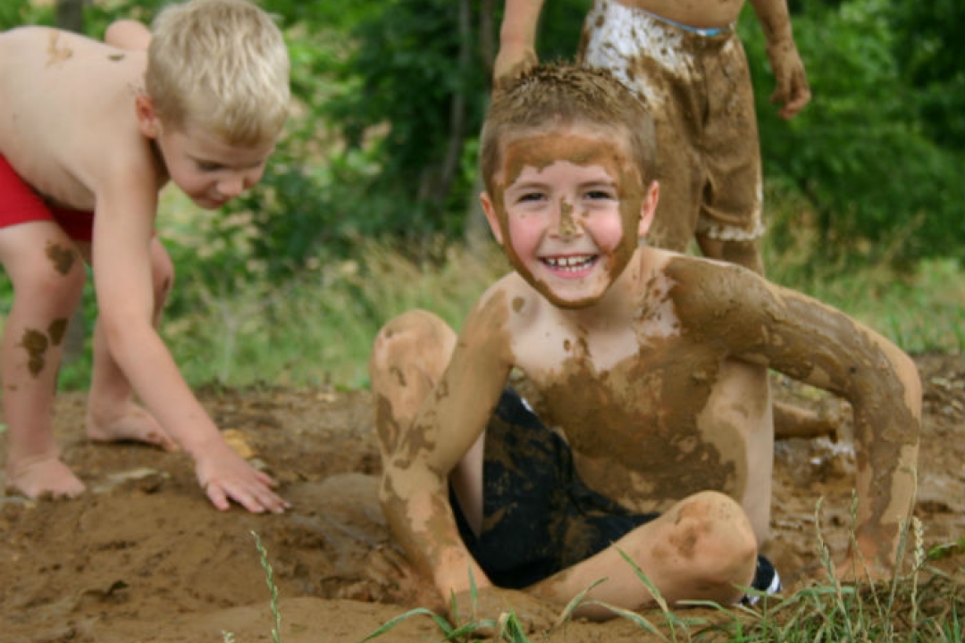 Boys playing in the mud.