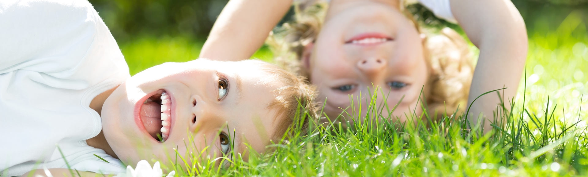 young children playing in grass
